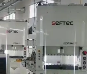 SEFTEC punching machine with JoeSure high-speed clip feeder in use